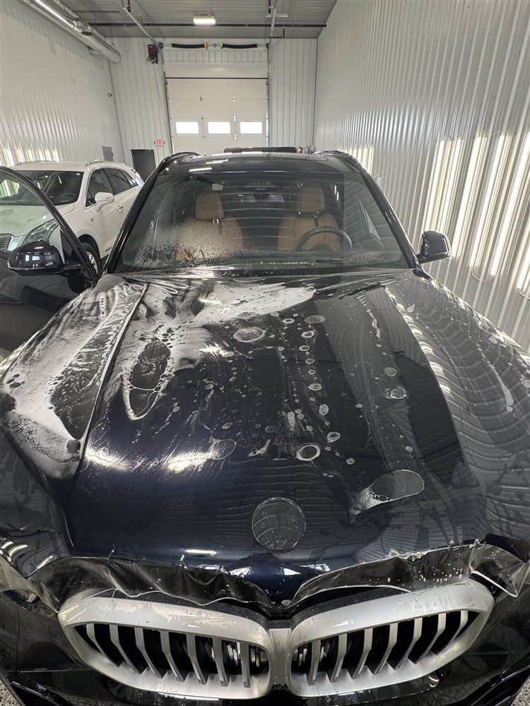 BMW being prepped and washed for paint protection film