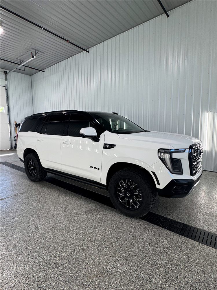GMC Yukon with tuxedo wrap — blacked-out roof and pillars